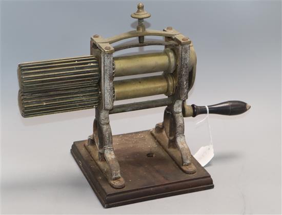 A Victorian brass and cast iron table top crimping machine, possibly for pea shelling